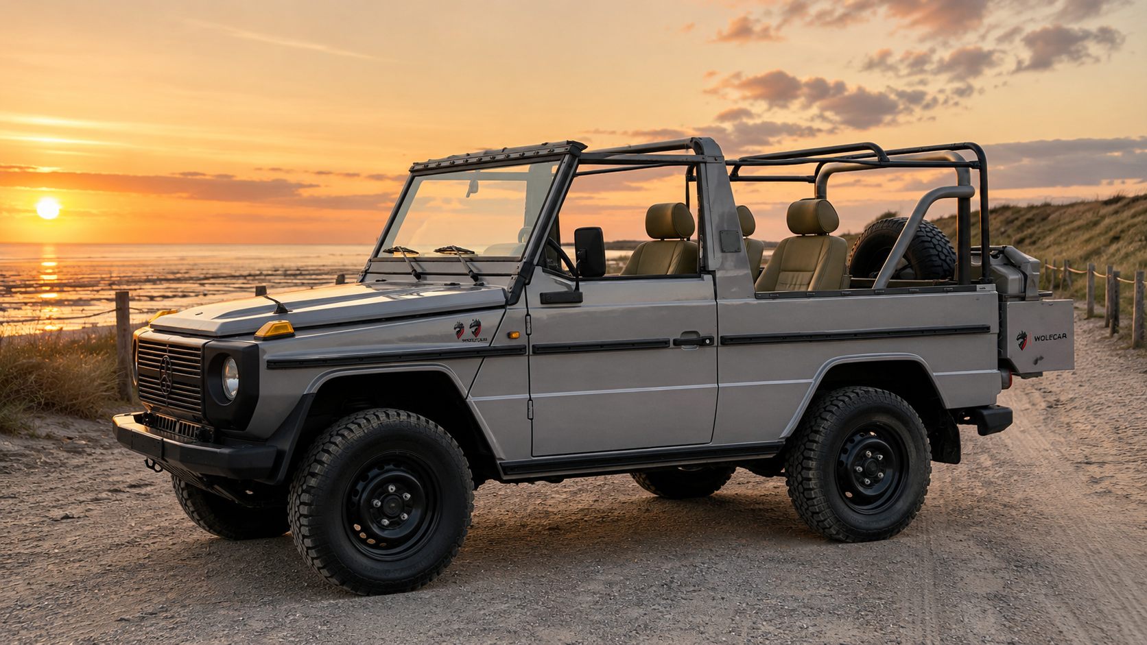 Open-top WOLF on a beach track at sunset